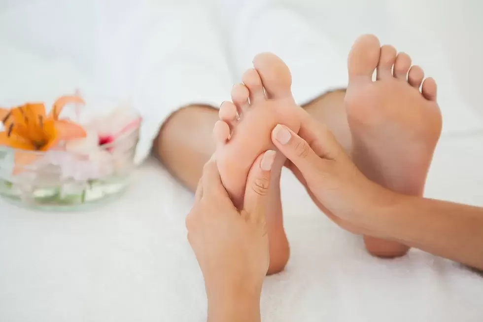 Picture of pretty woman receiving massage on  her feet  at Apple Spa 317-491-8917