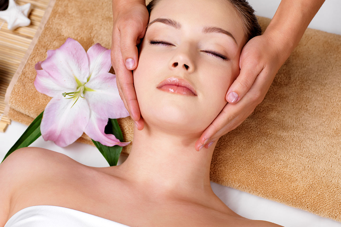 Picture of pretty woman receiving massage on sides of her neck & head, at Apple Spa 317-491-8917